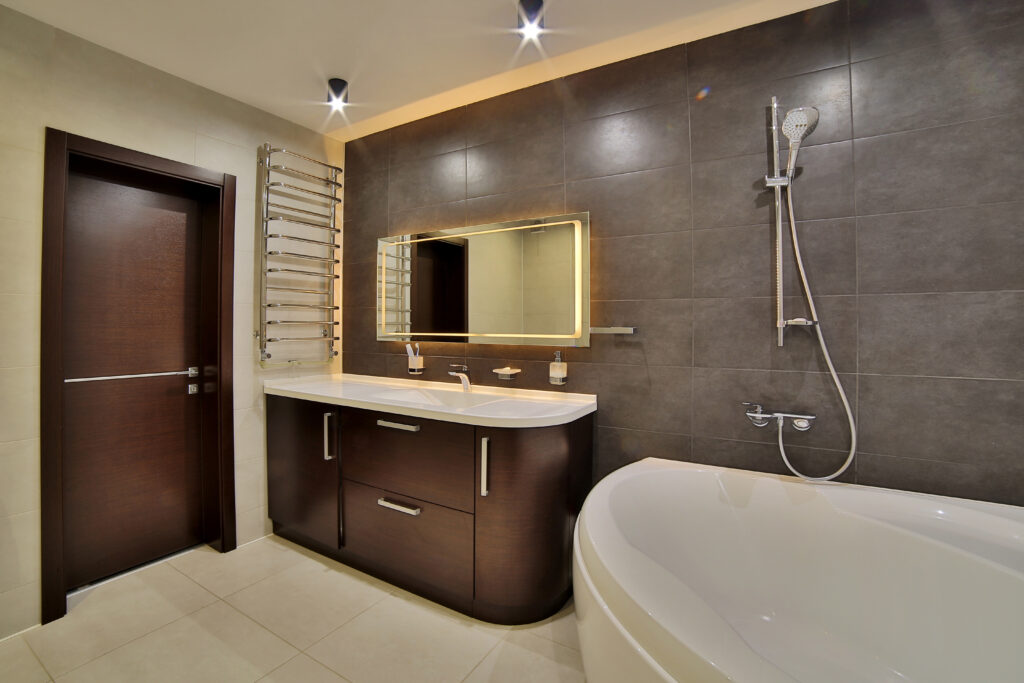 A luxury bathroom with a modern shower, bathtub, and vanity area, using a neutral color scheme.