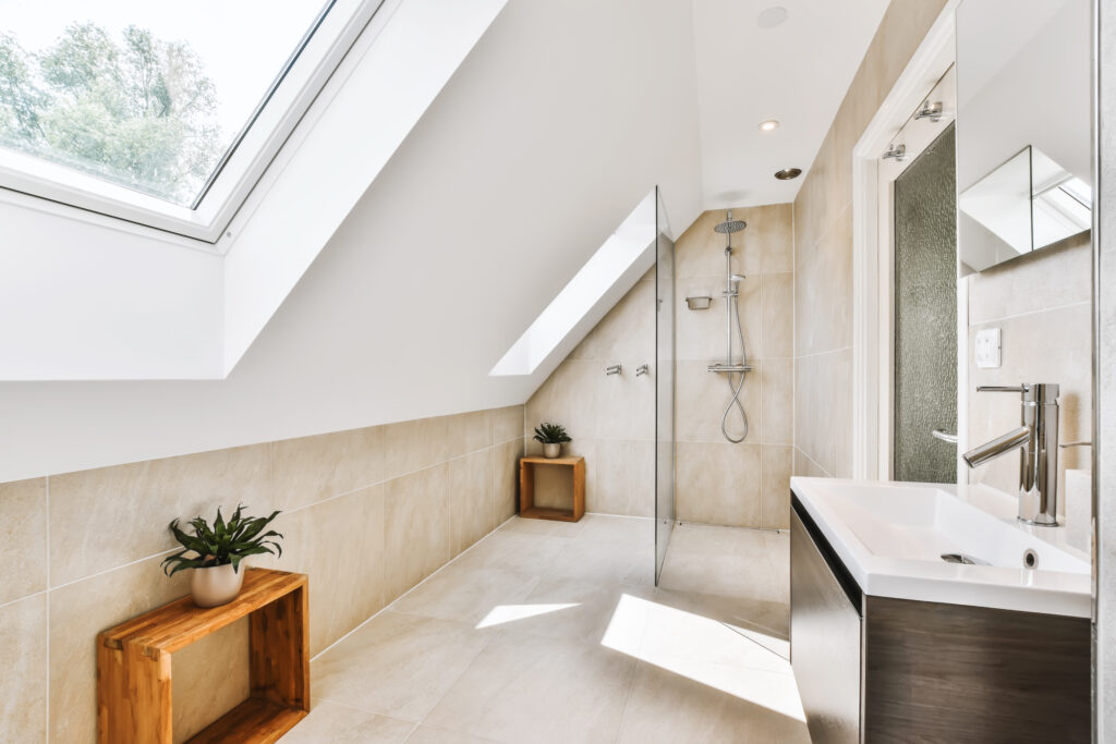 The interior of a beautiful walk-in shower with a window and tiled floor
